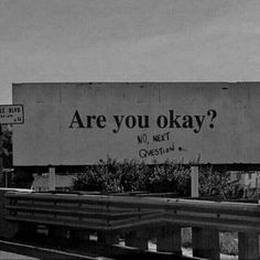 an old billboard with the words are you okay? written on it in black and white