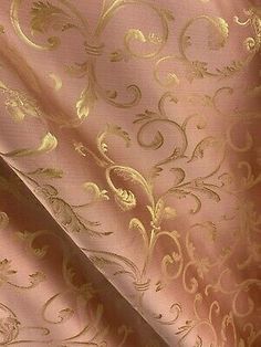 a pink and gold wallpaper with an intricate design on it's side,