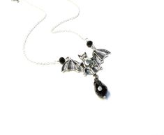 Silver bat necklace with black glass drop! Handmade. product details On a 18 inch (35.56 cm) silver plated chain with 3 inch (10.16 cm) extender chain. Bat is silver plated. 2 inches wide (5.08 cm) Faceted black glass drop I hope you enjoy my handmade creations and please visit the rest of my shop for items: https://www.etsy.com/shop/AnEnchantingCreature Thank you for supporting small business VISIT MY SHOPS HERE * http://www.etsy.com/shop/HappyCatHouse * http://www.Etsy.com/shop/AnEnchantingCre Bat Choker, Jewelry Vampire, Necklace Vampire, Vampire Necklace, Bat Jewelry, Bat Necklace, Goth Necklace, Vampire Goth, Mermaid Necklace