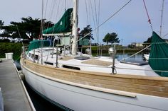 a sailboat docked at a dock in the water