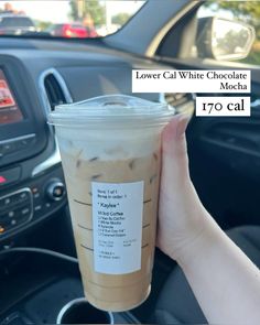 a person holding up a cup of iced coffee in their hand with the text lower call white chocolate mocha on it