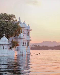 a large white building sitting on top of a lake