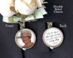 two personalized photo pendants attached to a suit jacket with flowers in the back