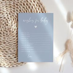 a card with the words wishes for baby written on it next to some dried flowers