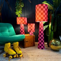 two yellow roller skates sitting next to each other in front of a green chair