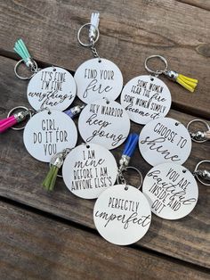 six personalized key chains with tassels on them, all in different colors