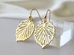 These dainty leaf earrings have a radiant shine, and they reflect light beautifully!  A simple, yet elegant filigree design, graces the leaves. Minimalist and classy, which makes them easy to coordinate with your favorite attire.    Product details: * 18k Gold plated ear wires  * Gold plated leaves * Lead and nickel free - Length:  1.3 inches - Width:    .75 inches ❤ I also have these earrings available in silver. The link to my shop is below. https://www.etsy.com/shop/FlutterbirdCo My goal is to provide every customer with exceptional service. Please message me if you have any questions. Thank you for supporting my small business! Please visit my F.A.Q. and shop policy sections for additional information. Everyday Leaf-shaped Jewelry With Matching Earrings, Minimalist Leaf-shaped Jewelry With Matching Earrings, Elegant Leaf-shaped Everyday Jewelry, Elegant Everyday Leaf-shaped Jewelry, Gold Leaf-shaped Nickel-free Earrings, Minimalist Gold Leaf Earrings, Gold Leaf Earrings For Gift, Gold Leaf-shaped Earrings For Gift, Gold Leaf-shaped Pierced Earrings