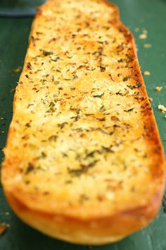 a piece of bread sitting on top of a green table