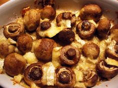 a casserole dish with mushrooms and cheese