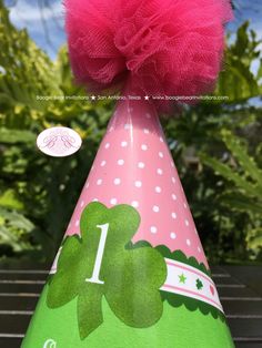 ☆FREE☆ economy shipping to USA on orders over $35! ► Shop today! Let's celebrate your Lucky Charm! This super cute party hat comes your honoree's name and age for an adorable pink lucky charm party. Your beautiful paper* hat is hand made to order with professional matte paper, printed with premium Canon ink. Each lovely party hat is then laminated for rigidity and longevity. This hand made pink tulle pom-pom and soft green tying ribbon are the perfect finishing touches on this adorable custom pa Novelty Pink Mini Hat For Birthday, Pink Novelty Mini Hat For Birthday, Playful Pink Mini Hats For Gifts, Playful Pink Mini Hat Gift, Whimsical Pink Birthday Party Supplies, Playful Pink Mini Hats For Birthday, Playful Pink Mini Hats For Birthdays, Cute Pink Party Supplies For Birthday Gift, Lucky Charm Party