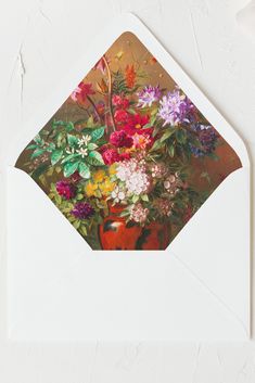 an envelope with a painting of flowers in a vase