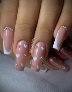 a manicure with hearts on it and white tips