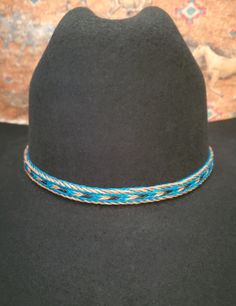 Braided Horse Hair Adjustable Hat Band in Brown/Black, Turquoise/Brown/Black, or Black/Brown/White, with 2 sliding knots make this hatband a great fit for most hats. This stunning hat band is made from genuine braided horse hair and will compliment your favorite cowboy hat.   - 3 braided strands are sewn together to create this gorgeous hatband. - Hat band measurements: approximately adjusts to 27.5" around and is 3/8 inch wide - Hat bands are shown on a size 7 hat.  Hats are not included. - See my horse hair KEEPSAKES to have a hat band made from your horse's hair:  https://www.etsy.com/shop/BlueEyesDesignsHB?ref=seller-platform-mcnav§ion_id=43697745 - See my HORSE HAIR hat bands:  https://www.etsy.com/shop/BlueEyesDesignsHB?ref=shop-header-name&listing_id=1296906619&from_page=listing&sec Handmade Southwestern Blue Hat Band, Blue Western Hat For Vacation, Adjustable Blue Hat Bands For Vacation, Handmade Blue Hat Bands With Curved Brim, Handmade Blue Hat Bands For Rodeo, Handmade Blue Hat Band For Rodeo, Adjustable Southwestern Turquoise Hat Bands, Casual Blue Hat Bands For Festivals, Adjustable Southwestern Blue Hat Band