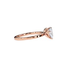 a rose gold engagement ring with a pear shaped diamond