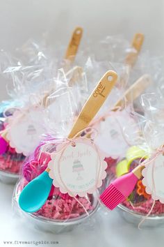 small plastic cups filled with colorful candies and toothbrushes on top of each other