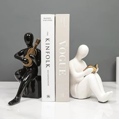 two black and white figurines sitting next to each other