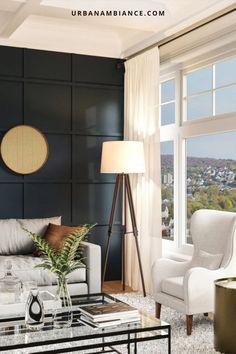 a living room with black walls and white furniture in the center, along with a large window