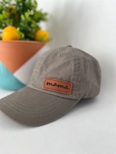 This Mama hat is such a fun basic that any busy mom can accessorize her outfit with. It's a great gift for a new mom, seasoned mom, any mom! A wonderful, unique idea for mother's day, a baby shower, or a birthday!  The deets: This hat is 100% cotton with a genuine leather patch. The patches are glued onto the hat. One size with an adjustable strap in the back. Currently only available in two colors, but more are coming!  Stock is constantly changing and some colors/styles are more limited than o Mama Hat, Idea For Mother's Day, Mom Hats, Hat Patches, Hat Ideas, Pew Pew, Cute Hats, Grey Women, New Mom