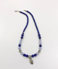 "Deep blue authentic lapis lazuli crystals contrast with blue lace agate brings out a stunning necklace with sterling silver spacers. The centrepiece is a RuYi scepter- representation of power and good fortune. A direct translation of RuYi 如意- is \"as u wish\". A traditional ruyi has a long S-shaped handles and a head fashioned like a cloud. Frequently appears in Asian art as a good luck motif. Lapis lazuli improves throat and lung health - in tune with personal spirit guardians to guide the wea Wish Symbol, Blue Lace Agate Necklace, Symbol Of Power, Herkimer Diamond Earrings, Shades Of Violet, Red Tourmaline, Lapis Lazuli Crystal, Rose Gold Studs, Blue Lapis Lazuli