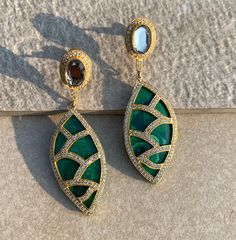 Green Kundan Emerald Polki Long Earrings, inspired by Sabyasachi, showcase exquisite Moissanite Polki diamonds in a luxurious Jadau design. These statement earrings, crafted with Indian gold, embody Bollywood glamour and elegance. Perfect for making a grand impression, they highlight the richness of traditional Indian jewelry. *𝐏𝐑𝐎𝐃𝐔𝐂𝐓 𝐃𝐄𝐓𝐀𝐈𝐋* * Material: Brass * Plating: Gold Plated *Stone:  Semi Precious Emerald, Kundan and Polki *𝐃𝐈𝐌𝐄𝐍𝐒𝐈𝐎𝐍𝐒* *Weight: 13 gm Each, Length: Formal Fusion Meenakari Danglers, Formal Fusion Style Meenakari Danglers, Luxury Kundan Earrings, Luxury Earrings With Intricate Design For Festivals, Elegant Green Meenakari Earrings, Luxury Kundan Earrings With Intricate Design, Luxury Earrings For Festivals, Luxury Festive Drop Earrings, Luxury Meenakari Earrings For Festive Occasions