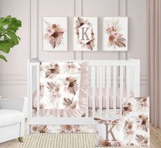 a baby crib bedding set with pink flowers and monogrammed wall art