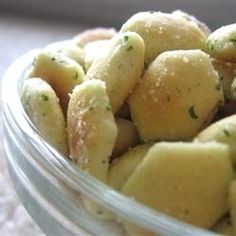 a glass bowl filled with green and yellow food on top of a white table cloth