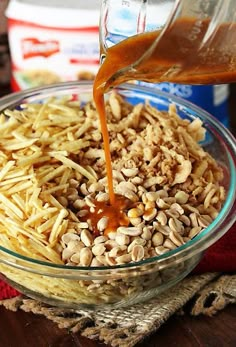 a glass bowl filled with oatmeal sitting on top of a wooden table