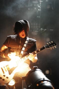 a man playing an electric guitar on stage