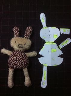 a teddy bear next to a cut out paper bunny