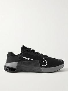 a black and grey nike shoe with white accents on the upper half of the shoe