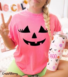 Get into the festive spirit with our pink pumpkin Halloween shirt, featuring a cute jack o' lantern face with eyelashes! This Comfort Colors Halloween shirt is perfect for celebrating a pink Halloween in style. Available in a variety of colors, this shirt offers a soft, comfortable fit that you'll love to wear all season long. Whether you're heading to a pumpkin patch or enjoying autumn festivities, this pumpkin crewneck is a versatile addition to your fall wardrobe. Ideal for pumpkin lovers, th Pumpkin Pocket Shirt, Spooky Pink T-shirt For Halloween, Patches Shirt, Pink Pumpkins, Pink Halloween, Unique Halloween, Pumpkin Shirt, Pumpkin Faces, Halloween Looks