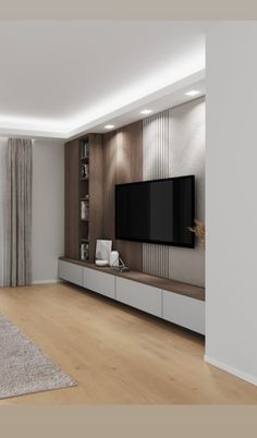 an empty living room with a large tv on the wall and wooden flooring in front of it