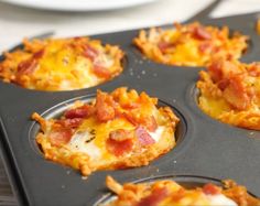 mini pizzas with cheese and bacon in a muffin tin