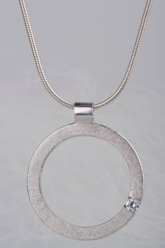 Are you looking for a gift idea for women? How about this minimalist and delicate sterling silver pendant necklace? You can choose which stone you prefer - diamond or zircon. Combination of the brilliant and delicate stone and rough, scratched silver surface makes the necklace look modern, but still subtle and elegant. Since both stones are birthstones (diamond is April birthstone and zircon is December birthstone) this necklace will be a great birthday gift for women. But it would also be a goo Modern Necklace With Single Diamond And Round Pendant, Modern Necklace With Single Diamond In Round Pendant, Modern Necklaces With Single Diamond Round Pendant, Modern Necklace With Single Diamond On Round Pendant, Modern Necklace With Single Round-cut Diamond, Modern Necklace With Single Round Cut Diamond, Modern Sterling Silver Jewelry With Round Stone, Modern Sterling Silver Round Stone Jewelry, Minimalist Silver Jewelry With Round Cut