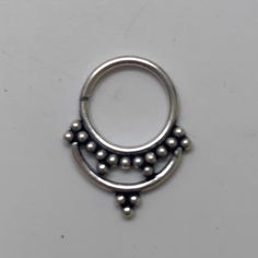 "These are so pretty and light. Made is 925 sterling silver with tribal details. The rings are all 10mm (1cm or .40\") in diameter. The wire is 18 gauge. They are only finished on one side since each one is made BY HAND so there may be very slight differences. One of the images contains numbers to specify which you would like from the drop down menu." Sterling Silver Septum Ring, Adjustable Nickel Free Silver Body Jewelry, Adjustable Nickel-free Silver Body Jewelry, Nickel Free Silver Metal Nose Rings, Silver Pierced Metal Nose Rings, Nickel-free Silver Metal Nose Ring, Nickel-free Sterling Silver Septum Ring, Nickel-free Bohemian Septum Ring, Bohemian Nickel-free Septum Ring