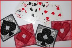 four playing cards are laying on top of each other with hearts and spades in them