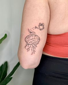 a woman's arm with a small tattoo on the left side of her body