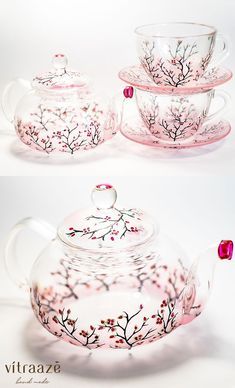 the tea pot is decorated with pink flowers and leaves on it's glass lid