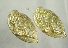 Beautiful Victorian and Art Nouveau raw brass stampings. 1. Oval cats: 2" long x 1 1/2" high (50mm x 38mm); Four sweet kitties on a raised hollow backed substantial stamping.  2 pieces available(SOLD OUT) 2. Angel: 2 1/4" long x 1 1/4" high (57mm x 31mm); Oval left facing angel laying on her side on her wings with flowers and leaves.  Raised stampings with hollow backs.  7 pieces available Brass stampings in very good condition, ready to go for brooches, pendants or fairy gardens. 1 piece with order Limited to stock on hand.  These are the only pieces like this. Made in the USA Here are some other Vintage raw brass stampings: www.etsy.com/listing/1092221466; www.etsy.com/listing/1129214502; www.etsy.com/listing/1143144481; www.etsy.com/listing/1142983379; www.etsy.com/listing/854888232; ww Art Nouveau Angel, Victorian Cat, Cat Stamp, Brooch Diy, Brass Art, Beautiful One, Raw Brass, Fairy Garden, Vintage Brass