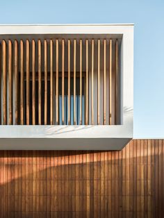 a wooden slatted window on the side of a building