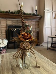 a vase filled with flowers sitting on top of a table next to a fire place