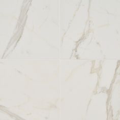 four different angles of marble tiles with white and grey veiners on them, all showing the same color