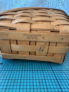 a wooden basket sitting on top of a blue tiled floor