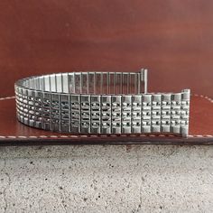 NOS unused  old-stock 1966 Speidel Tempest stainless steel beads of rice expansion watch bracelet.  The ends are straight 3/4" (18.8mm), you can file them to 11/16" (17.2mm-18mm).  Spring bars are included, remember to tell us what size you need.  The length at the spring bars is 6 3/8" (162mm).    We can shorten it for no extra charge and might have links to add, send a message with length you need before purchase and we'll see if it can be done.  52D.25921 Classic Silver Watch Band With Jubilee Bracelet, Classic Adjustable Silver Watch Band, Classic Stainless Steel Watch Bands With Jubilee Bracelet, Vintage Silver Stainless Steel Watch Accessories, Retro Round Silver Watch Accessories, Classic Stainless Steel Jubilee Bracelet Watch Bands, Classic Stainless Steel Jubilee Watch Bands, Vintage Silver Adjustable Watch Bands, Vintage Adjustable Silver Watch Bands