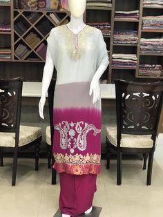 A stunningly marvelous outfit. This outfit features kashmir tilla and aari fusion embroidery on the front neckline and ghera (hemline) of the shirt. The dupatta features 4-sided embroidered border with big embroidered paisleys design in the middle. The shirt and dupatta feature Banarsi Brocade taping.- - - - - - - - - - - - - - - - - - - - Product DetailsCondition: Brand NewF A B R I CShirt: Viscose GeorgetteDupatta: Viscose GeorgetteLower: Indian CrepeColor: Grey-Pink Double Shaded*Kindly note Anarkali Sets With Resham Embroidery In Raw Silk, Embroidered Chanderi Sets For Traditional Ceremonies, Designer Raw Silk Sets With Dabka Work, Dola Silk Straight Kurta Set With Resham Embroidery, Traditional Drape Sets With Dabka Work For Designer Wear, Diwali Zari Work Sets In Georgette, Navratri Sets With Resham Embroidery In Raw Silk, Designer Saree Dresses For Transitional Season, Unstitched Dola Silk Sets For Traditional Ceremonies