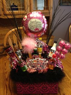 a pink and black birthday basket on a table