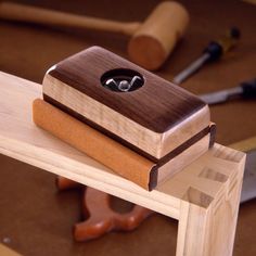 a wooden box sitting on top of a piece of wood