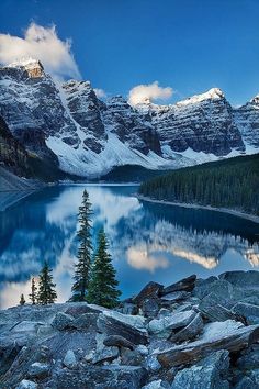 a lake with mountains in the background and a bible verse written on it's side