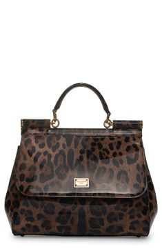 Signature Dolce&Gabbana panache and modern aesthetics merge on this leopard-print coated calf hair handbag from the Kim Kardashian runway collection. Magnetic-snap flap closure Top carry handle; removable, adjustable shoulder strap Interior zip and wall pockets Structured silhouette with flat base and protective metal feet Leather lining Genuine calf hair (China) Made in Italy Designer Handbags Chic Double Handle Bag In Leopard Print, Chic Leopard Print Bag With Double Handles, Chic Double Handle Leopard Print Bags, Chic Leopard Print Tote Satchel, Top Handle Bags In Leopard Print, Luxury Leopard Print Top Handle Bag, Leopard Print Shoulder Bag With Gold-tone Hardware, Luxury Leopard Print Shoulder Bag With Double Handle, Leopard Print Bag With Double Top Carry Handle