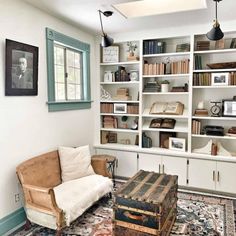 a living room filled with lots of books and furniture